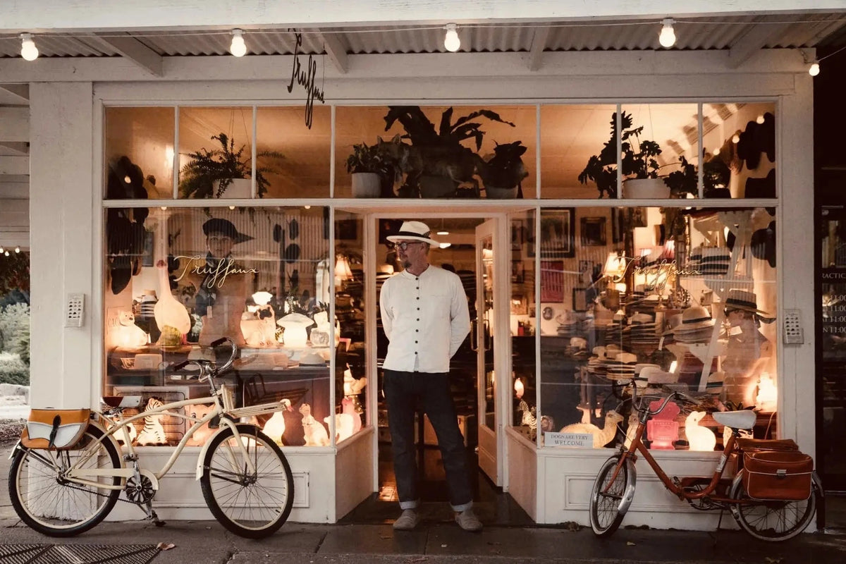 Oska at the Truffaux hat shop in Olinda, with hats displayed in the windows